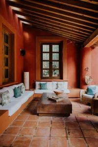a living room with a couch and a table at Hotel Casa De Quino in Querétaro