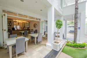 a dining room and kitchen with tables and chairs at Belvedere Boutiqe Hotel in Windhoek