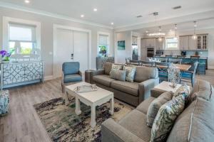 a living room with two couches and a kitchen at Coastal Chic by Brightwild-Pool & Boat Dock in Stock Island