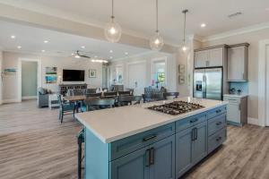 a kitchen and living room with a stove top oven at Coastal Chic by Brightwild-Pool & Boat Dock in Stock Island