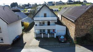 an aerial view of a house with a car parked in the driveway at Pitlane-Apartment in Herresbach