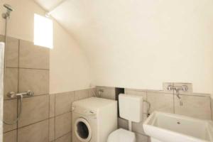 a bathroom with a toilet and a sink at Corte Antica 2 in Presicce