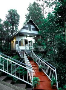 a home with a staircase leading to a house at vattachalil villa in Anachal