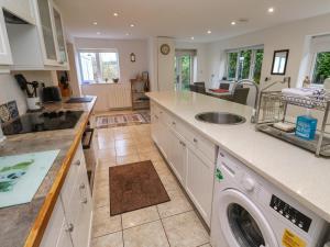 a kitchen with a washer and dryer in it at Alice Cottage in St. Agnes