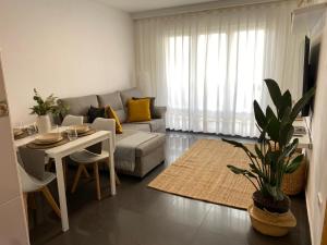 a living room with a couch and a table at Sobrecueva Paraiso I in Cangas de Onís