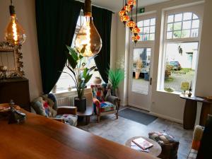 a living room with a table and a large window at Boutique Hotel in Bad Salzuflen