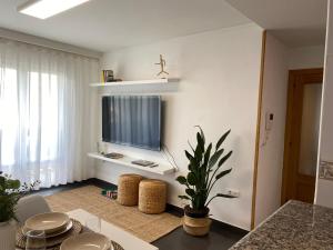 a living room with a flat screen tv on a wall at Sobrecueva Paraiso I in Cangas de Onís