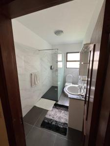 a bathroom with a shower and a toilet and a sink at Mountain retreat in Boaventura