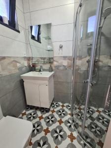 a bathroom with a shower and a sink at Къща за гости Софаш 