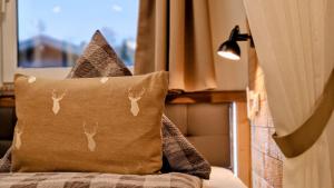 a pillow with deer heads on it sitting on a bed at Kienberg - Modernes 2-Zimmer-Apartment im Allgäu-Stil mit Alpenpanorama in zentraler Lage in Pfronten in Pfronten +19 photos