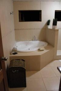 a bathroom with a bath tub with a sink at JuanDolio Guavaberry +3Brd 13p/p in Juan Dolio