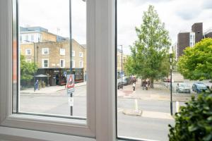 a view of a city street from a window at Omega - 3BD Gem in De Beauvoir Town in London