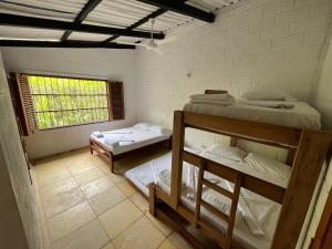 a room with two bunk beds and a window at Cabaña Pazatiempo Sapzurro in Sapzurro