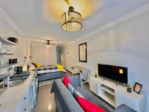 a living room with a couch and a kitchen and a bed at Jirah@Riverside in Centurion
