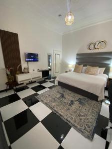 a bedroom with a bed and a black and white floor at Ditoro Boutique Hotel in Pretoria