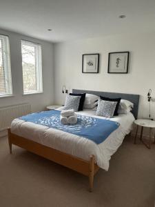 a bedroom with a large bed with two towels on it at The Apartment Boscawen Woods in Truro