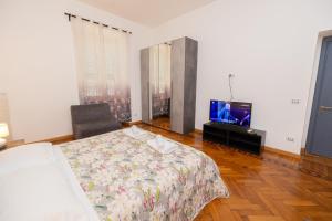 sypialnia z łóżkiem i telewizorem w obiekcie Adriana sweet apartment w Rzymie