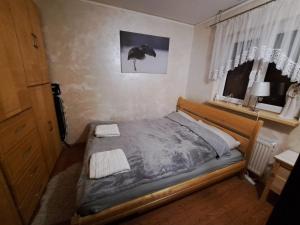 1 dormitorio con 1 cama con 2 toallas en Dom drewniany z ogrodem, en Szczecinek