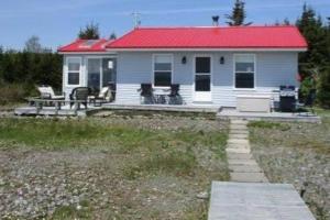 a small white house with a red roof at Beach Bliss, Great View in Guysborough