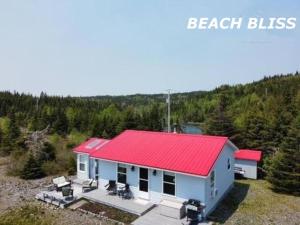 a house with a red roof on a hill at Beach Bliss, Great View in Guysborough