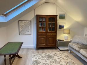 a living room with a couch and a book shelf at Cille Apartments, Ballyferriter village in Ballyferriter