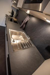 a kitchen counter with a sink on top of it at Appartement an der alten Linde in Weil
