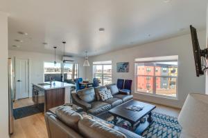 a living room with a couch and a table at Modern Bozeman Condo with Balcony and Mountain Views! in Bozeman