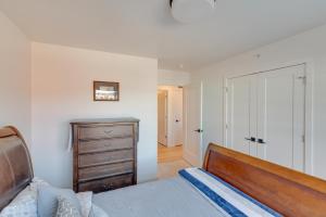 a bedroom with a bed and a dresser and a closet at Modern Bozeman Condo with Balcony and Mountain Views! in Bozeman