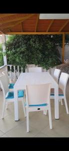 a white table and chairs on a patio at Rüyakent Sea Panorama in Didim
