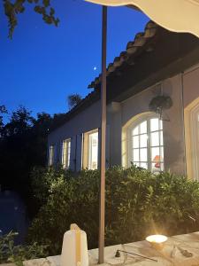 a candle on a table in front of a house at les petites terrasses in Grasse