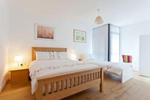 a bedroom with a large bed and a night stand with a lamp at Luxury ground floor 2 Bedroom apartment Bangor. in Bangor