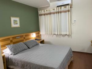 a bedroom with a bed and a window at Hotel Solarium Express in Cambé +9 photos