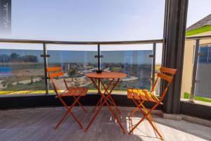 a table and two chairs on a balcony with a view at Beautiful Seaview Superior Room in Bakau in Bakau