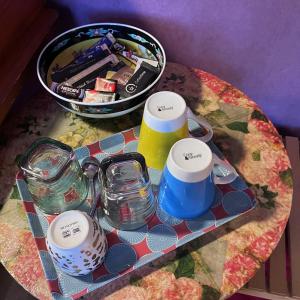 - une table avec un plateau de verres et un bol de nourriture dans l'établissement Camera et Caetera Chambres d'hôtes B&B, à Roubaix