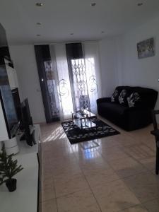 a living room with a couch and a coffee table at sweet house close to airport in El Prat de Llobregat