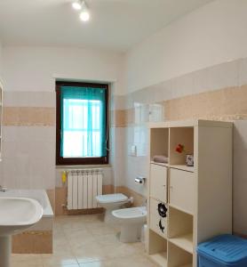 a bathroom with a sink and a toilet and a sink at Pia's house garden in Campobasso
