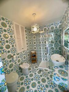 a bathroom with a toilet and a sink and a shower at La Cuchina in Capri