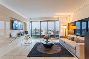 a living room with a couch and a table at Pestana Berlin Tiergarten in Berlin
