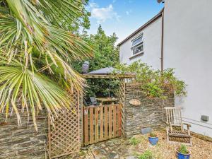 a garden with a wooden gate and a fence at 2 bed in Woolacombe 57907 in West Down