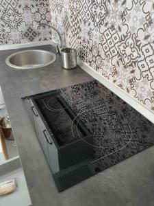 a kitchen counter with a sink and a stove at Civico 19 Guest House -Free Wi-Fi- in Salerno