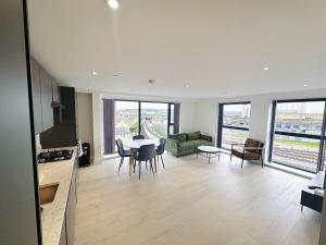 倫敦的住宿－Luxury Modern Flat Near Center，厨房以及带桌椅的起居室。
