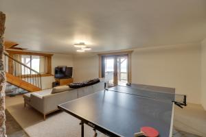 a living room with a ping pong table at Hand-Crafted Cabin with Whitefish Lake Views! in Whitefish