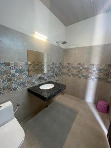 a bathroom with a sink and a toilet at VISTARA COURTYARD in Varanasi