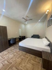 a bedroom with a large bed and a desk at VISTARA COURTYARD in Varanasi