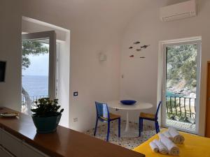 a dining room with a table and a view of the ocean at La Cuchina in Capri