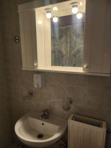 a bathroom with a sink and a cabinet with a mirror at 'Elia gytheio in Mavrovouni +17 photos