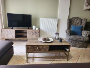 a living room with a tv and a coffee table at 'Elia gytheio in Mavrovouni