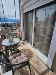 a patio with a table and chairs on a balcony at 'Elia gytheio in Mavrovouni