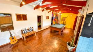 a living room with a ping pong table and a guitar at Apart Hotel de Alegria in Cusco