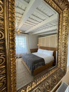 a bedroom with a bed and a large mirror at Narbona Wine Lodge in Carmelo